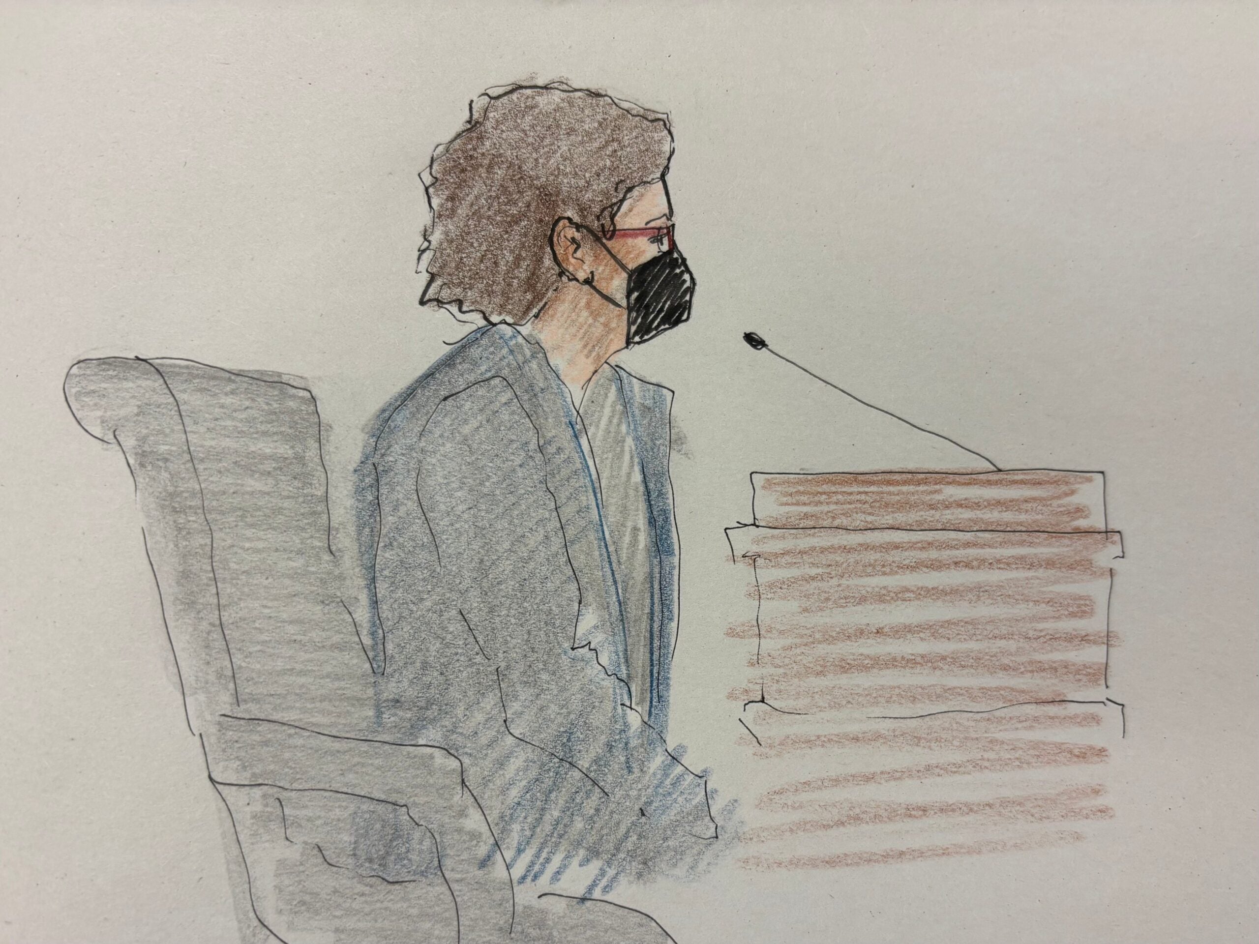 A person wearing a mask sits in a chair and speaks into a microphone at a witness stand in a courtroom sketch.