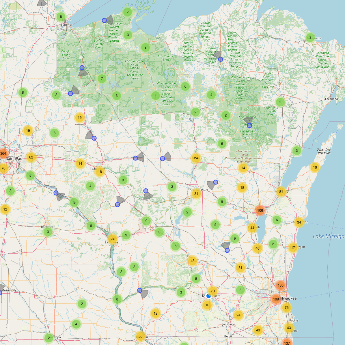 A detailed map of Wisconsin showing clustered data points in green, yellow, and blue, with major cities, highways, and regions labeled.