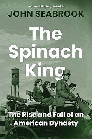 Book cover for The Spinach King by John Seabrook, featuring a black-and-white photo of people riding on a horse-drawn wagon with a water tower in the background.