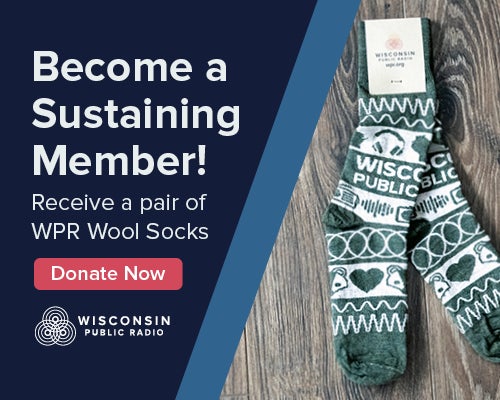 A pair of green and white wool socks is displayed next to text promoting Wisconsin Public Radios sustaining membership and donation offer.
