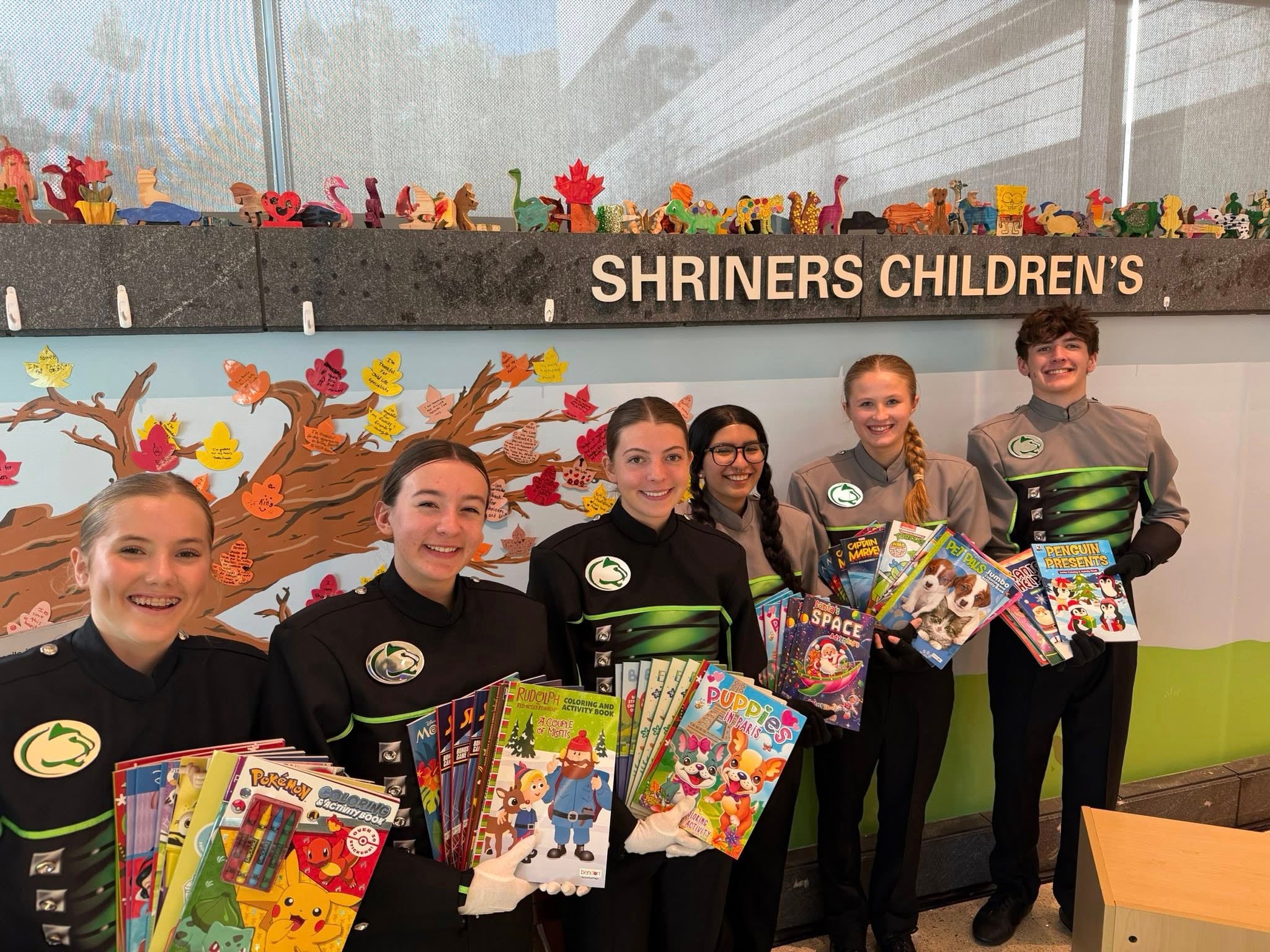 A group of people holding books.