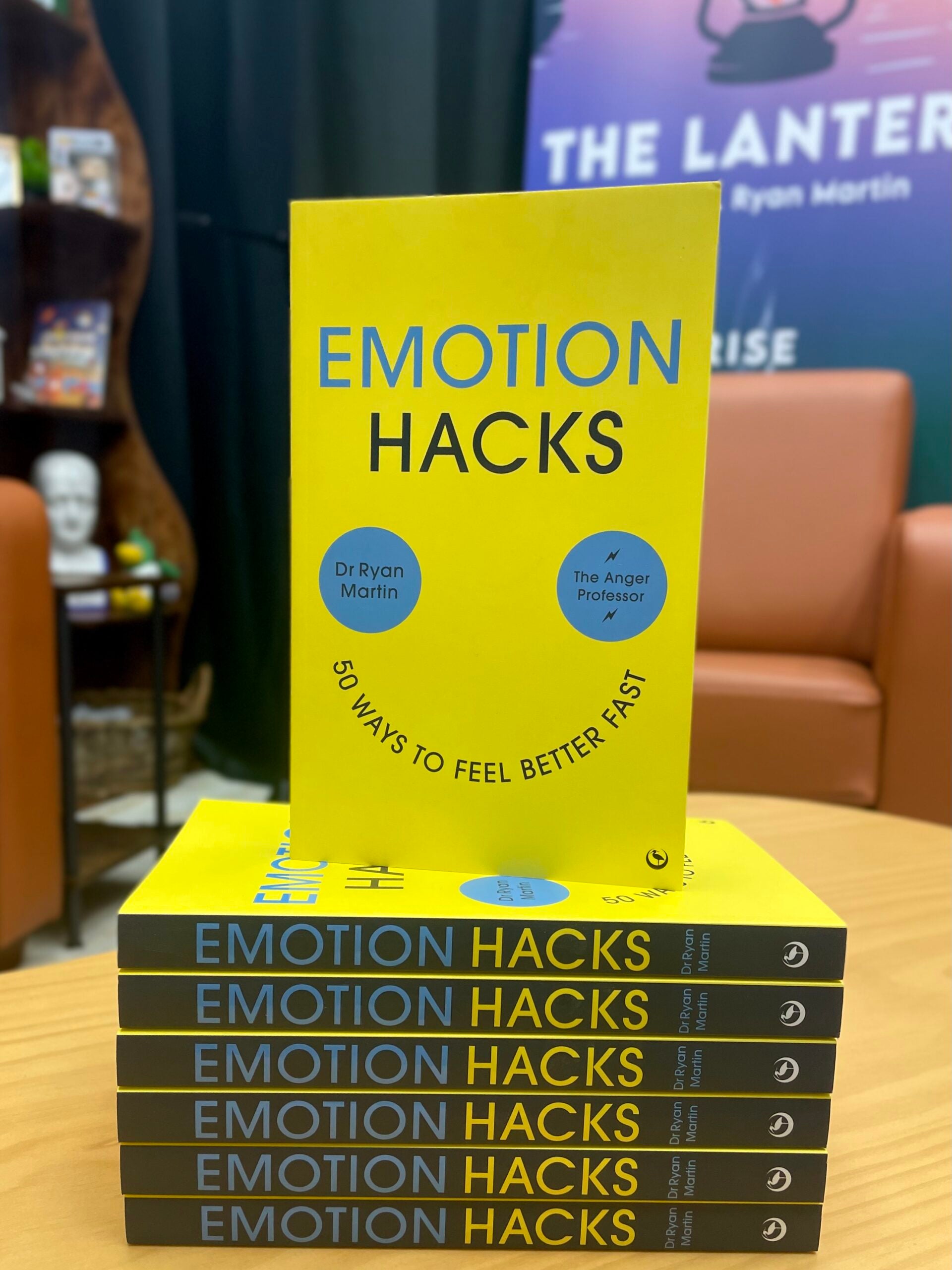 Stack of copies of the book "Emotion Hacks"