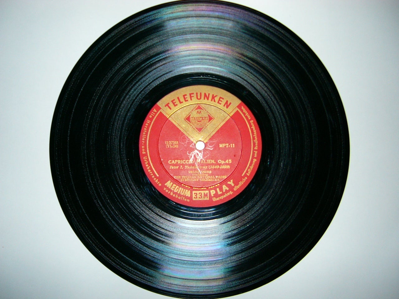 A black vinyl record with a red Telefunken label in the center, placed against a white background.