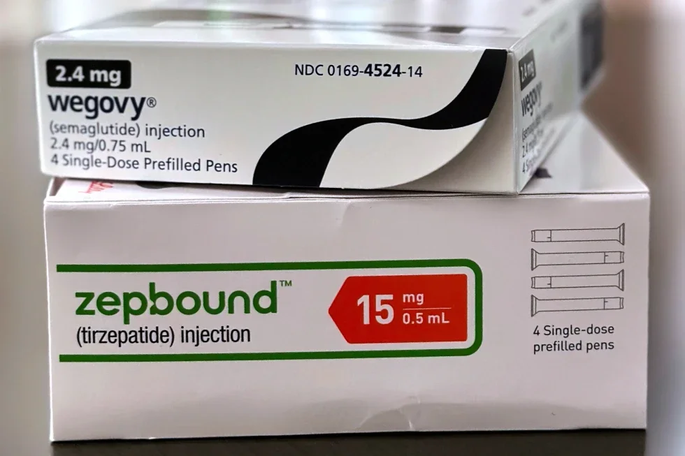 Two medication boxes stacked: the top is Wegovy (semaglutide 2.4 mg), and the bottom is Zepbound (tirzepatide 15 mg), both for injection with prefilled pens.